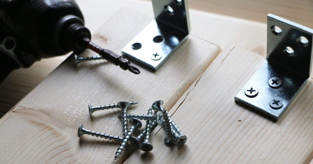 木材とL字金具を電動ドライバーで固定するDIY作業